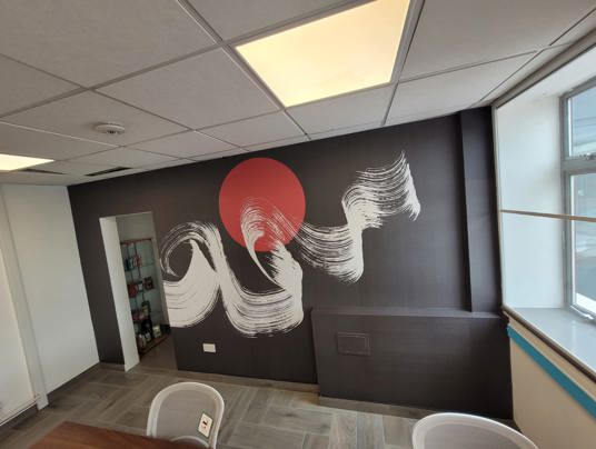 A printed accent wall in an open-plan workspace
